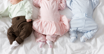 Mom praised for tying her triplets' sleeves together to stop them fighting