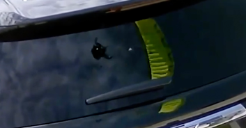 Chilling security footage shows the moment a skydiver crashed into man's front yard