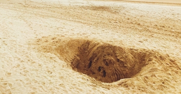 Girl who died at Florida beach after sand hole she'd been digging collapsed is named: 'My daughter is in there'