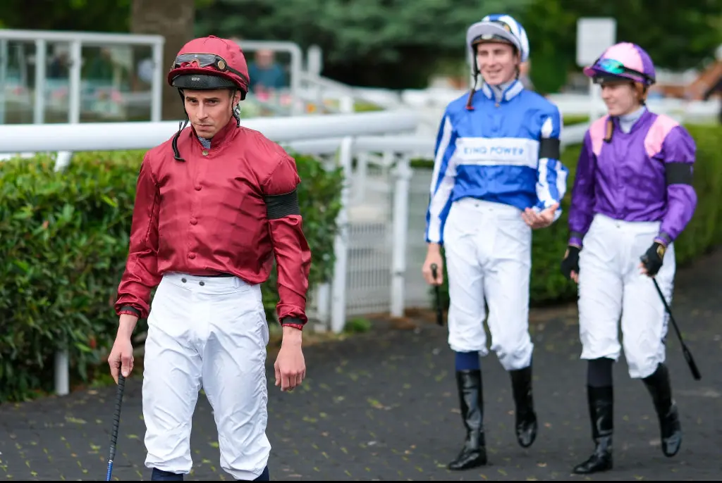 Jockeys at Kempton Park wear black armbands in support of John Hunt. Credit: Alan Crowhurst / Getty