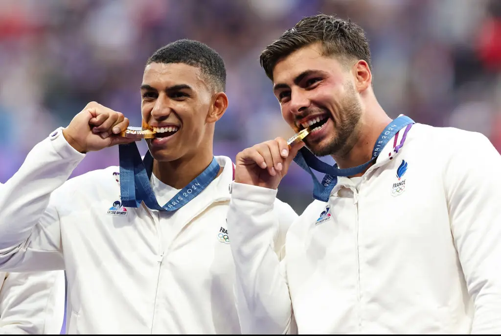 French players bite their Gold medals during the Paris 2024 Olympic Games. Credit: Icon Sportswire / Getty