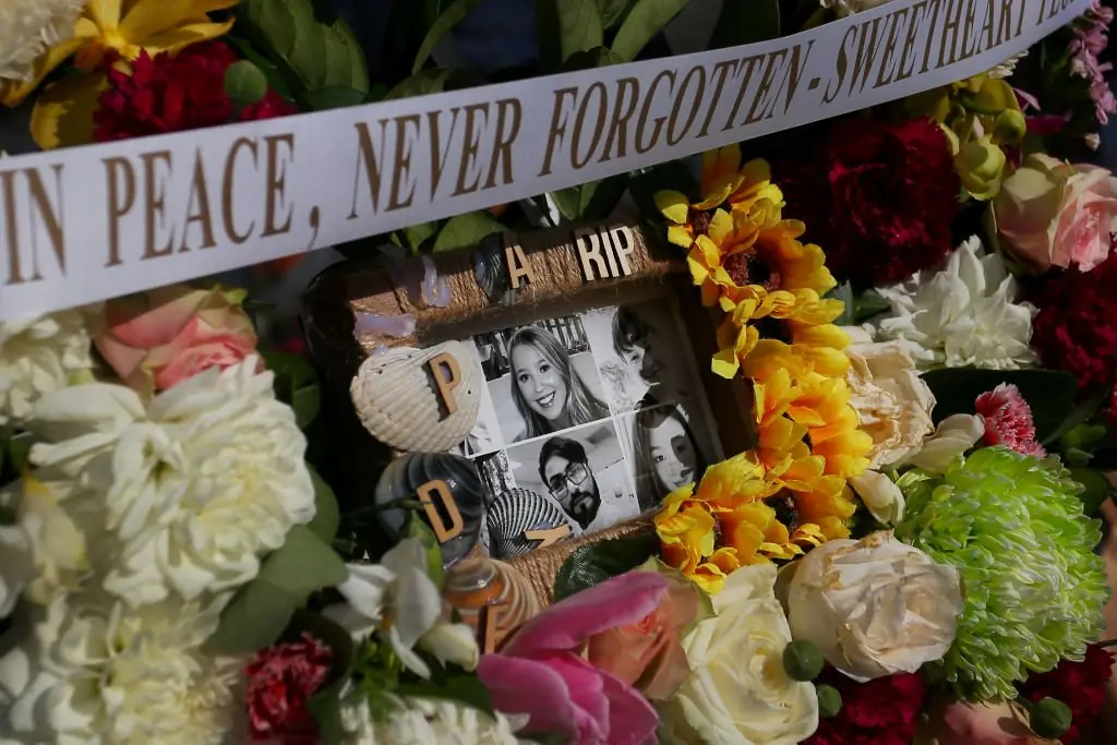 Flower tributes and condolence messages are seen at the edge of Westfield Bondi Junction. Credit: Lisa Maree Williams/Getty