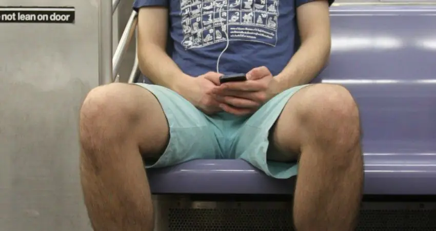 A woman has been punched in the face for asking a man not to manspread