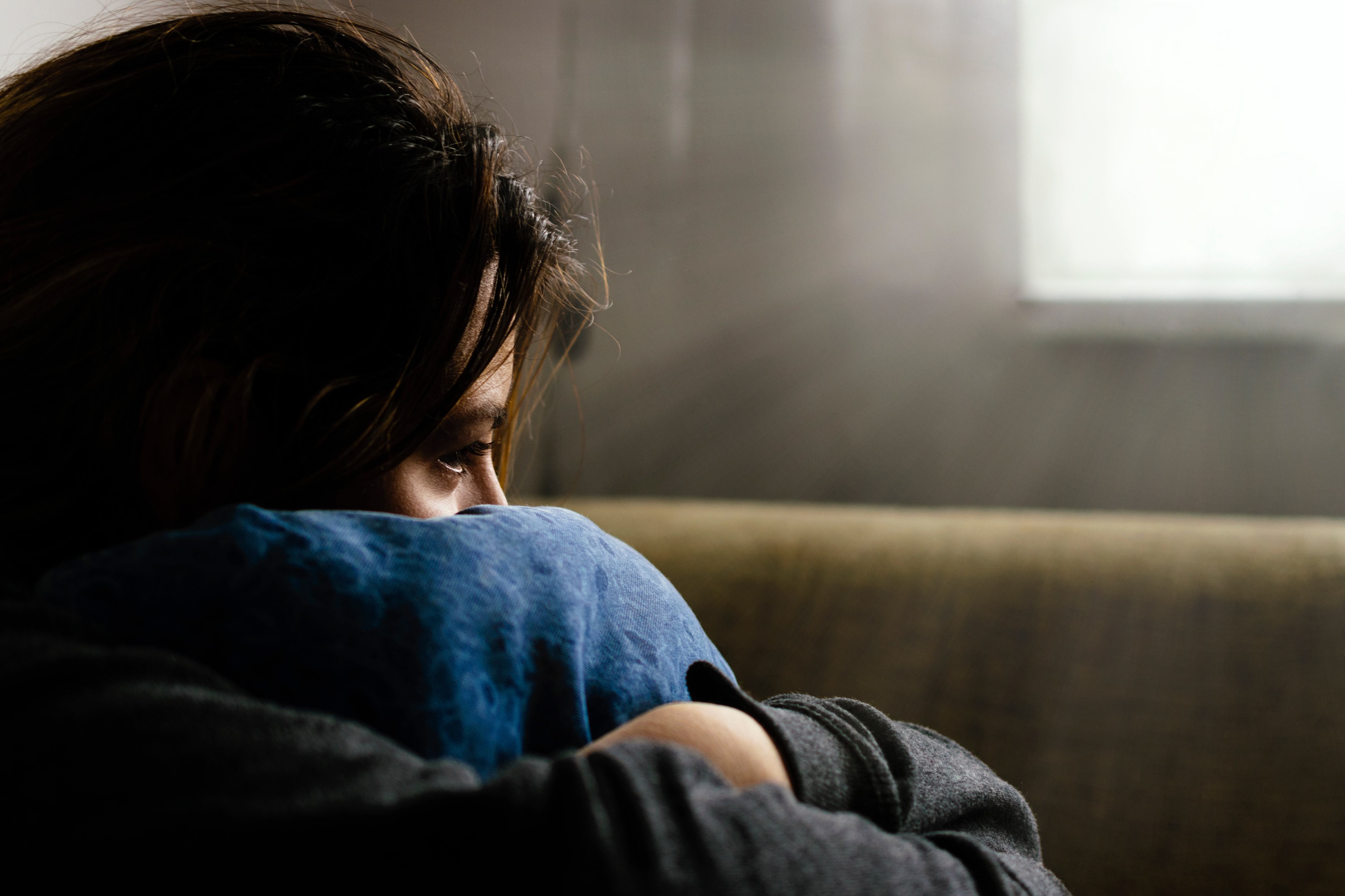 A girl hugs a pillow