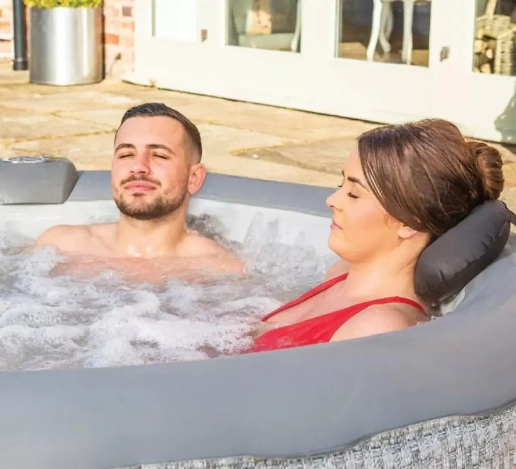 A couple relaxing in a hot tub. 