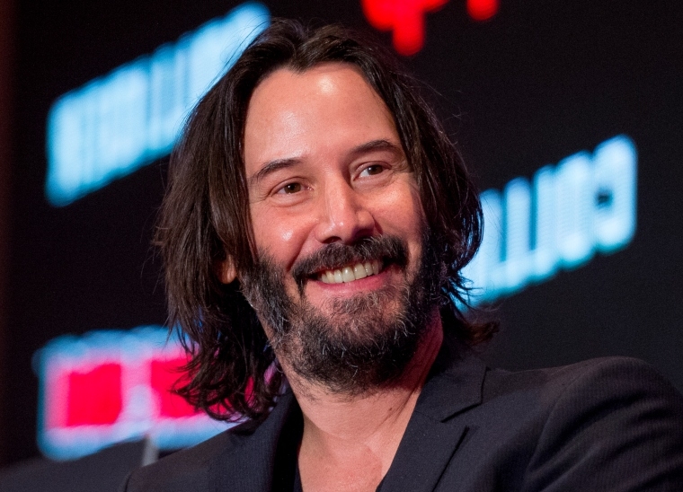 Keanu Reeves smiling.