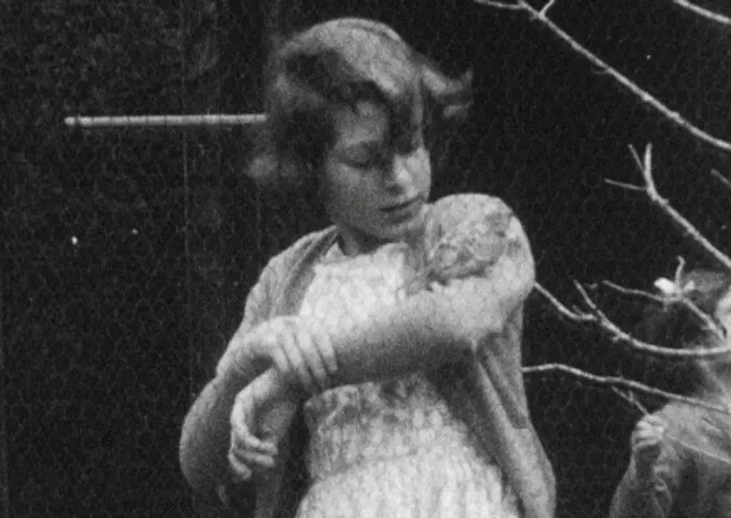 Archive footage of the Queen with a bird on her arm. 