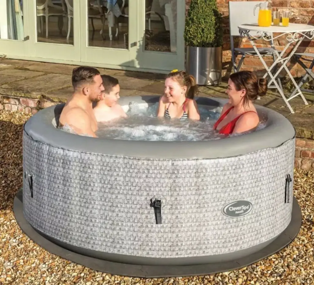 A smiling family in a hot tub. 