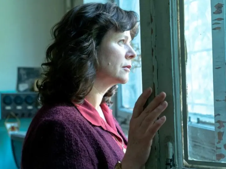 A woman looking out of a window.