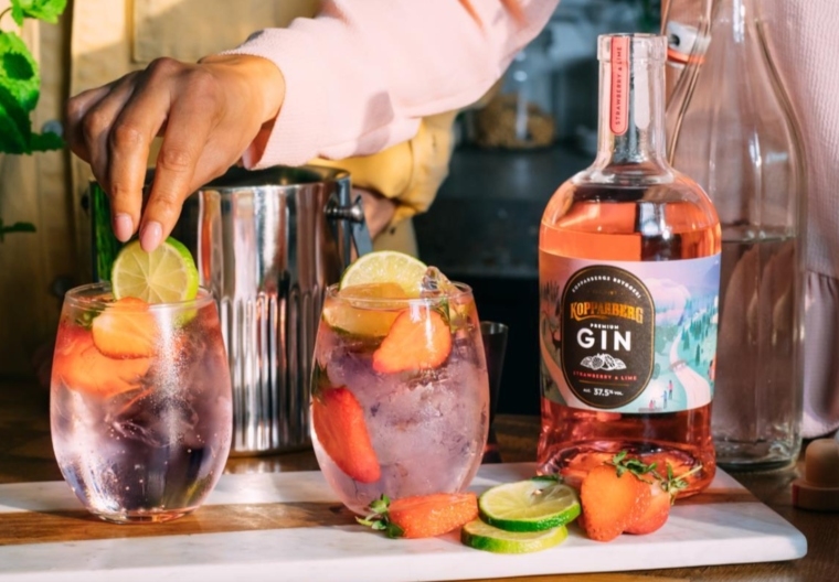 A man putting a lime in Kopparberg's new pink gin.