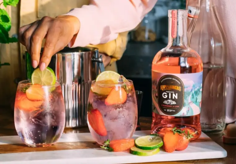 A man putting a lime in Kopparberg's new pink gin. 