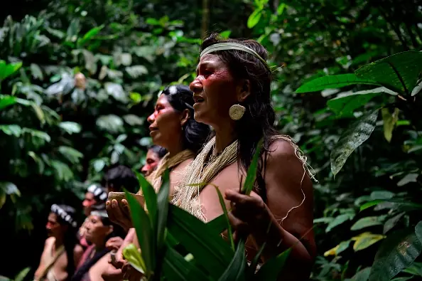 Waorani indigenous people sing at the Teata sacred waterfall, near the village of Nemompare, on the banks of the Curaray river, in Pastaza province, Ecuador on April 14, 2019. - The Waorani people of the Ecuadorean Amazonia are fighting before court to keep oil companies out of their territory. (Photo by RODRIGO BUENDIA / AFP) (Photo credit should read RODRIGO BUENDIA/AFP/Getty Images)