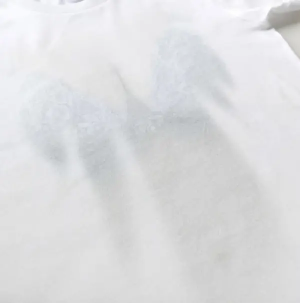 Breasts seemingly peaking through a white shirt.