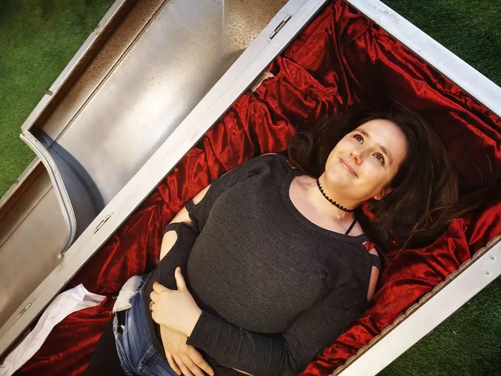 Erica Buist lying in a coffin.