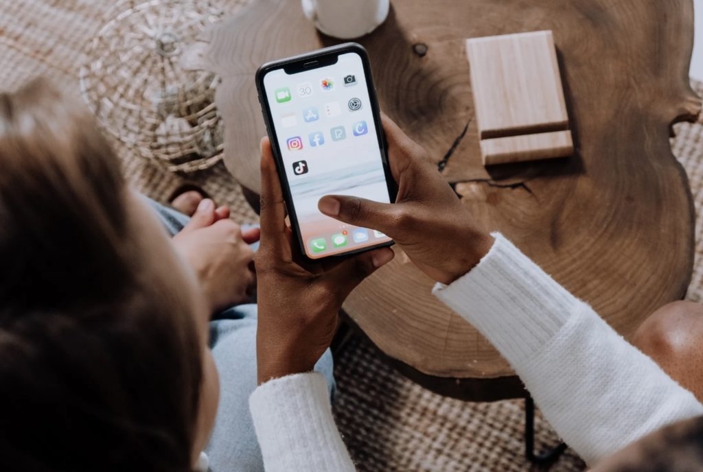 A mother and daughter looking at TikTok on a cell phone.