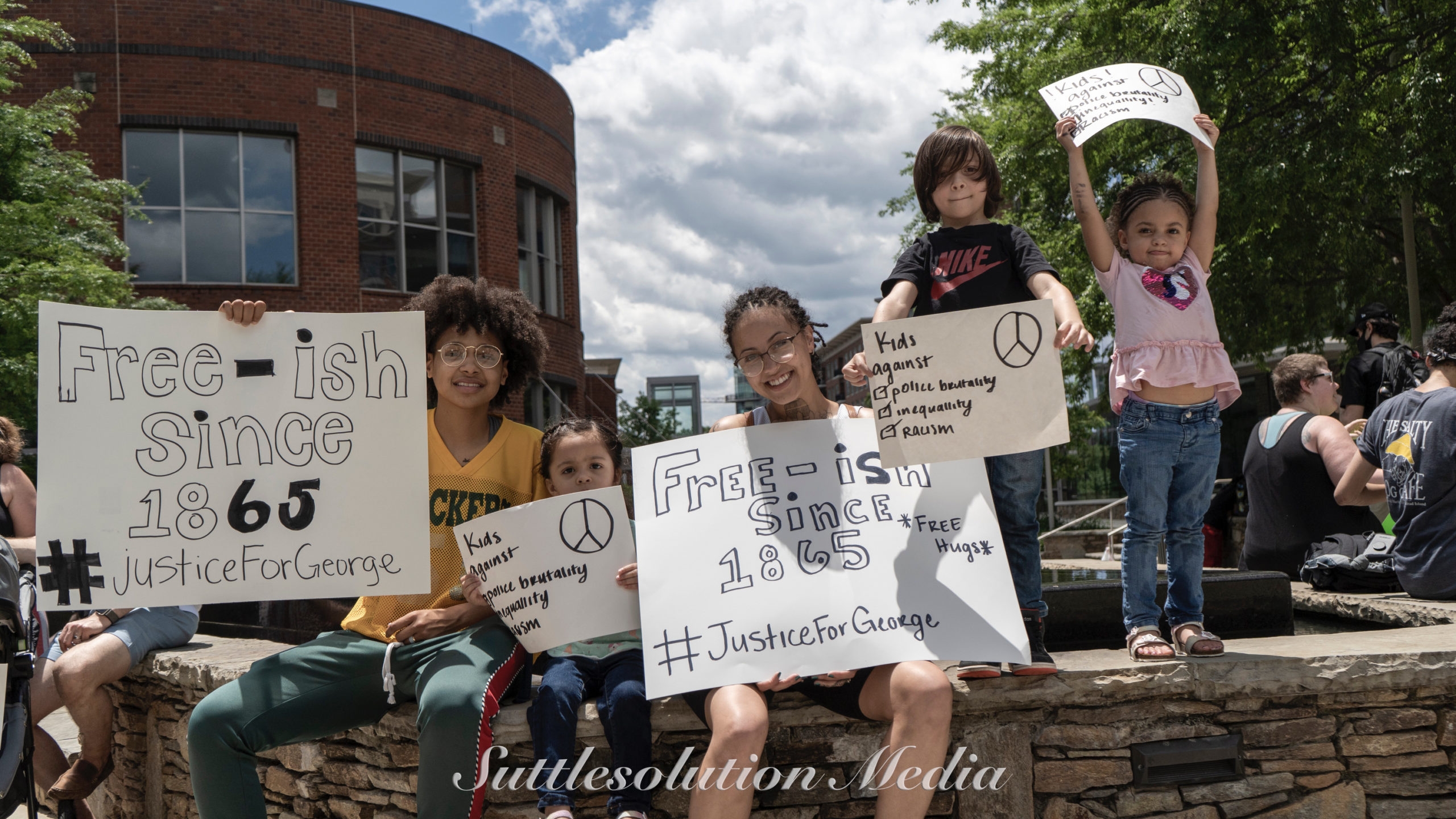 Children with Black Lives Matter signs.