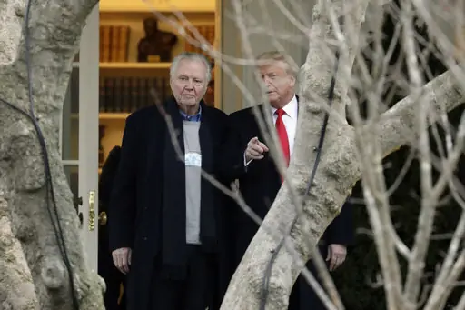 U.S. President Donald Trump points to the media with American actor Jon Voight outside the Oval Office.