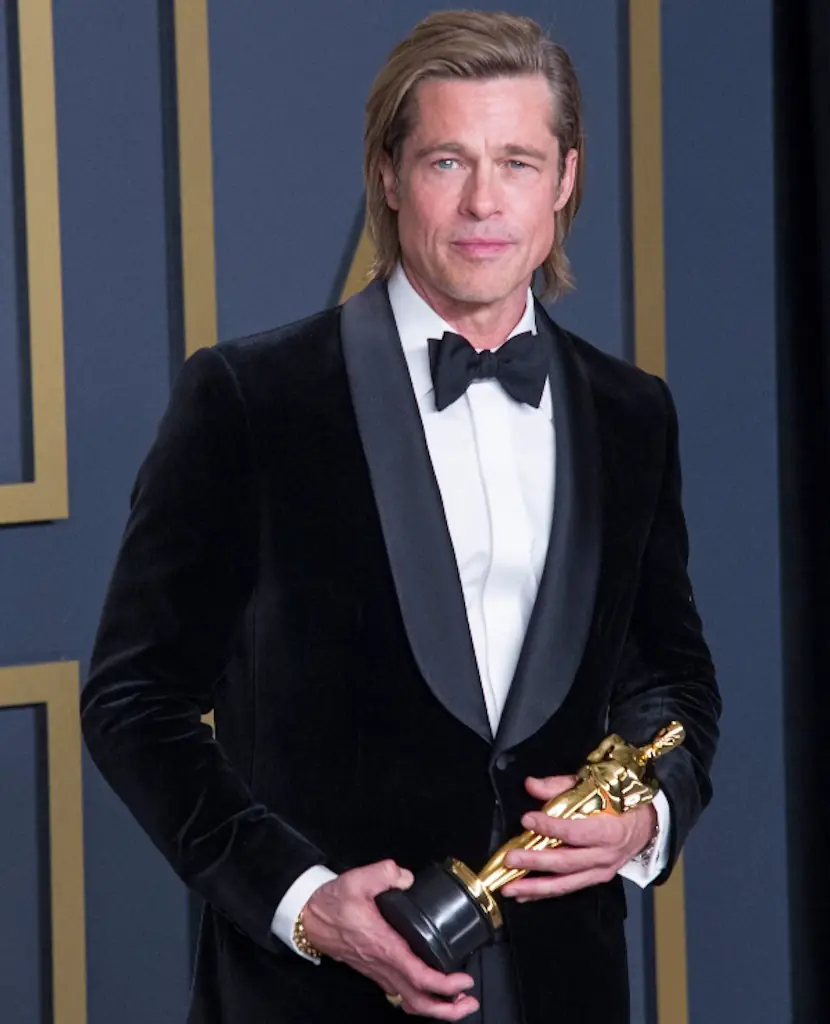 Brad Pitt holding an Oscar.