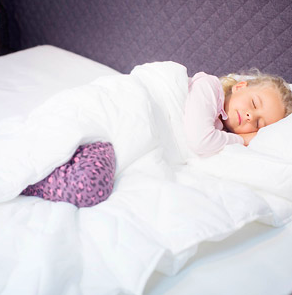 A child sleeping in a holey quilt.