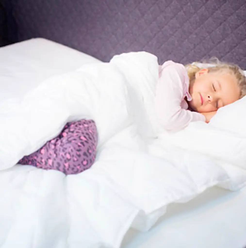 A child sleeping in a holey quilt.