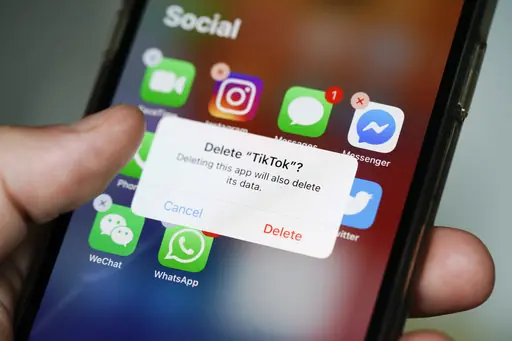 Somebody deleting the TikTok app from their phone.