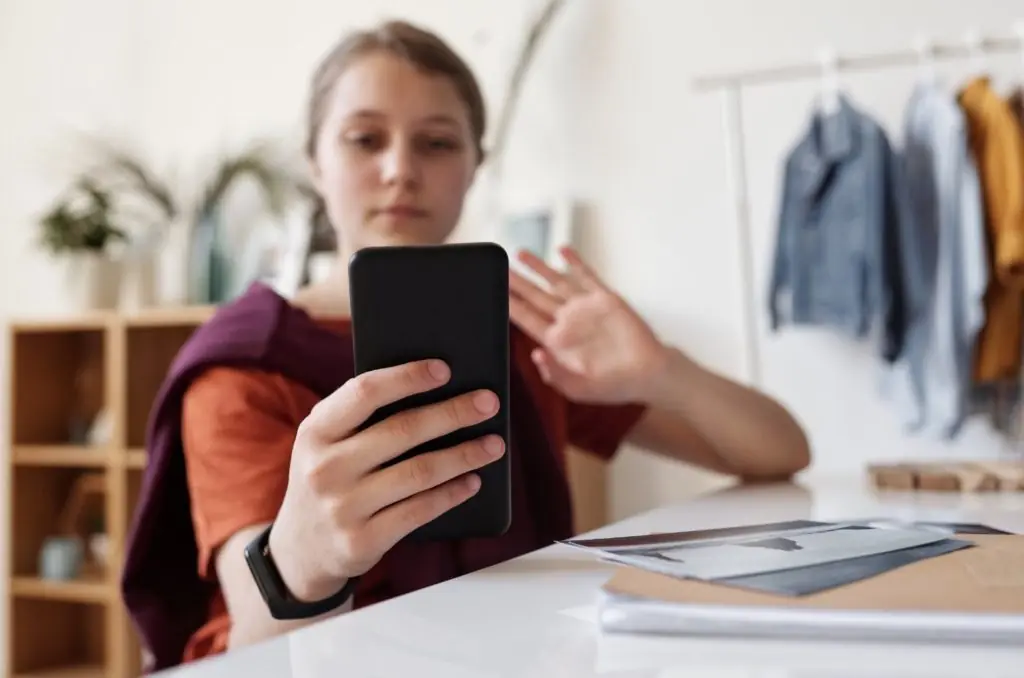 A young woman taking a selfie.