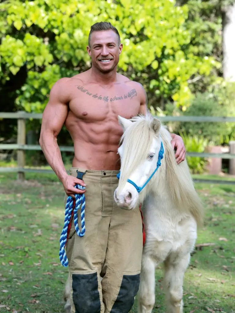 Firefighter Nathan with Dejavu the Pony. These salacious yet cute images depict hunky Australian firefighters posing with some of the most adorable animals Australia has to offer, for a caldendar all in the name of charity. See SWNS story SWBRcalendar. This saucy 2021 calendar depicts hunky Australian firefighters posing with some of the most adorable animals Australia has to offer. Now in its 28th year, the world’s most popular calendar is back for 2021. And after the year we’ve all had, the Australian Firefighters Calendar is certainly a sight for sore eyes. The annual calendar sets out to change the mood of doom and gloom from the past 8-months. 2019 and early 2020 was a particularly devastating time, and the world grieved with Australia as they suffered through catastrophic bushfires, and an estimated loss of 1 billion animals from the diverse native wildlife. While the fires may have gone, the destroyed bushland has made it impossible for many of the displaced wildlife to return to their natural habitat.