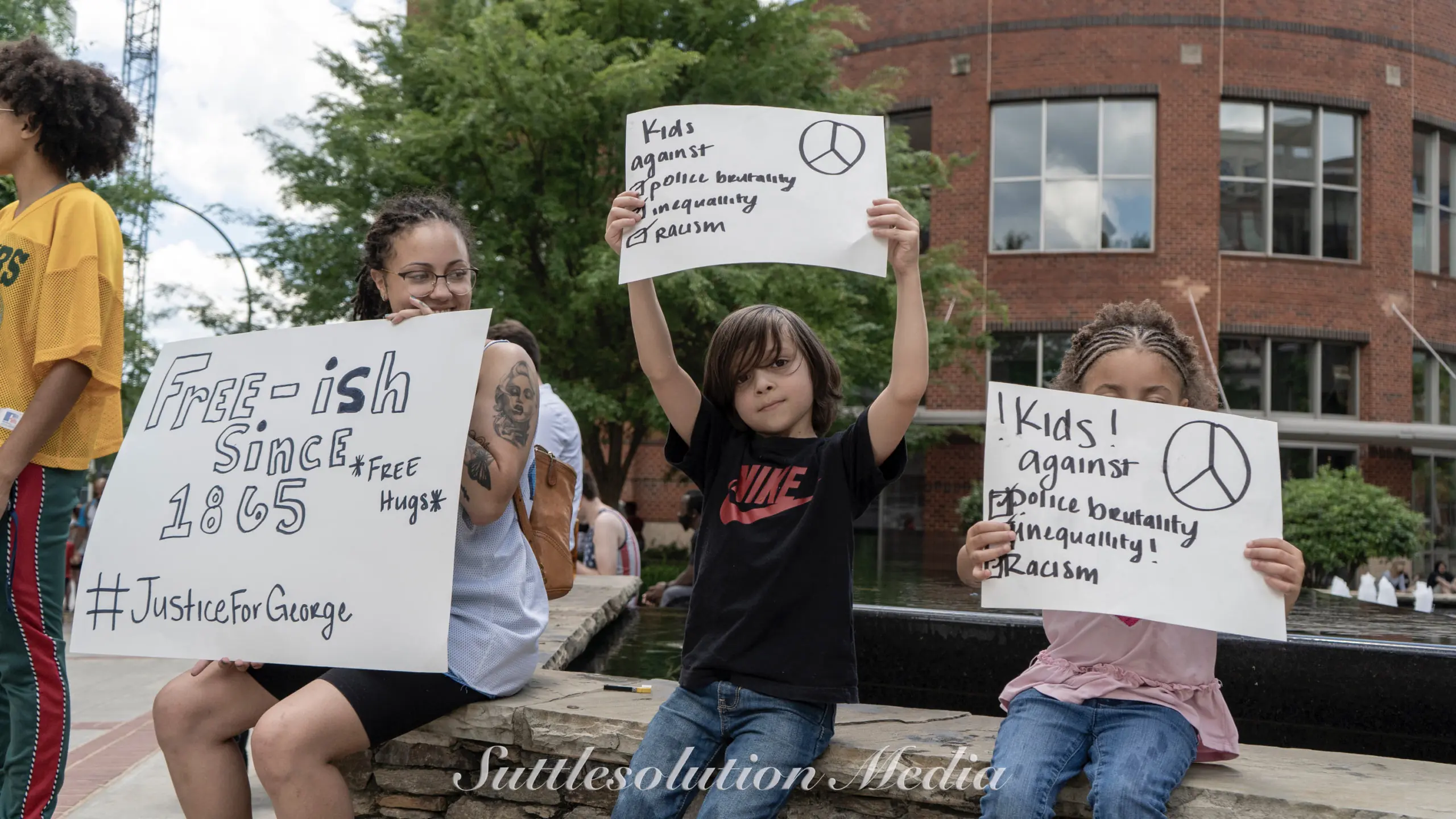 Children with Black Lives Matter signs.