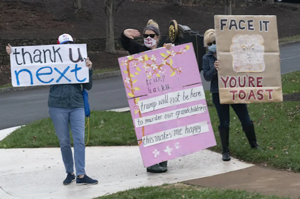 Protesters demonstrate as United States President Donald Trump arrives at Trump National Golf Club. 