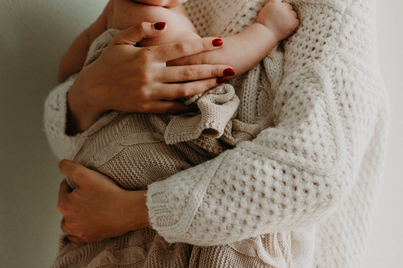 A woman holding a baby.
