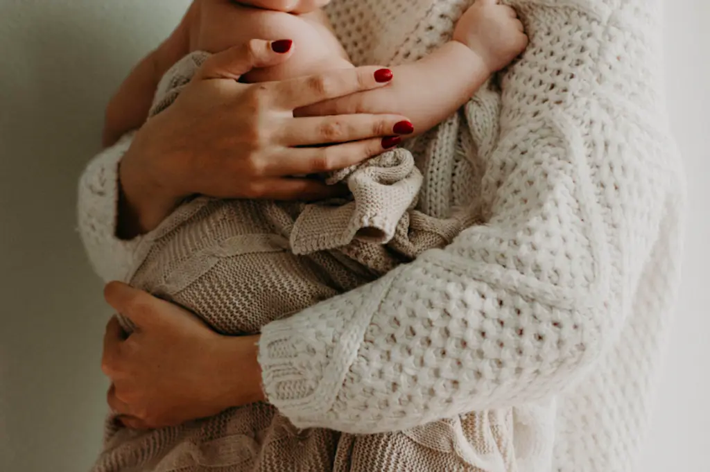 A woman holding a baby.