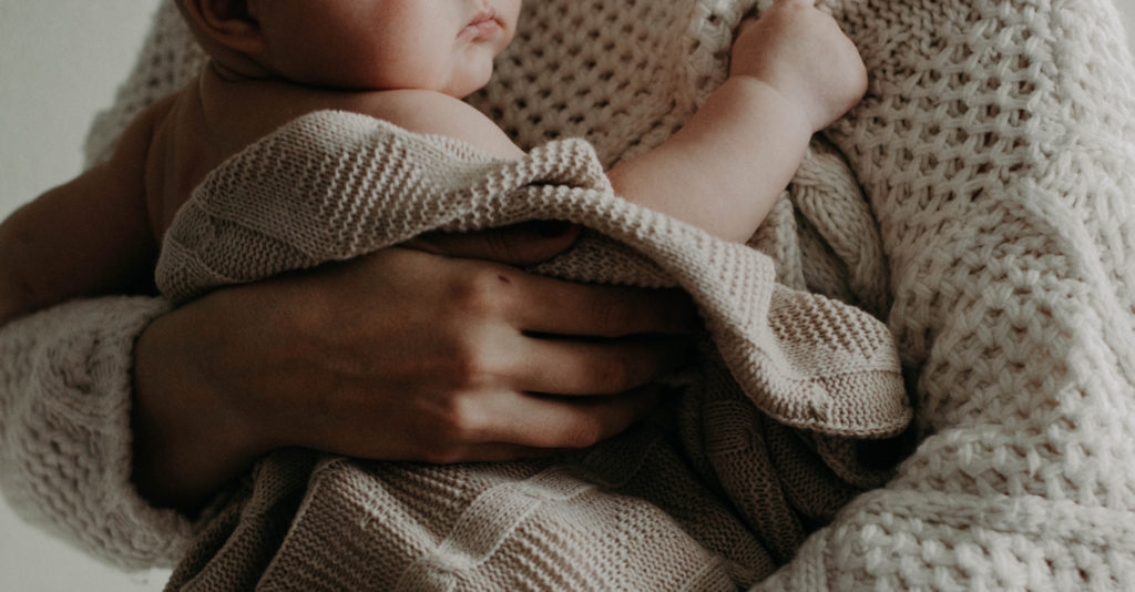 A mom holding a baby.