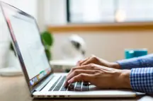 A man at a laptop.