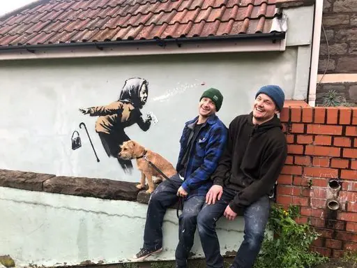 Sam Hunt (left), 28, and Fred Loosmore (right), 28, who recently moved out of a house on Vale Street, next to a confirmed Banksy mural that has appeared on a wall in Vale Street, Bristol.