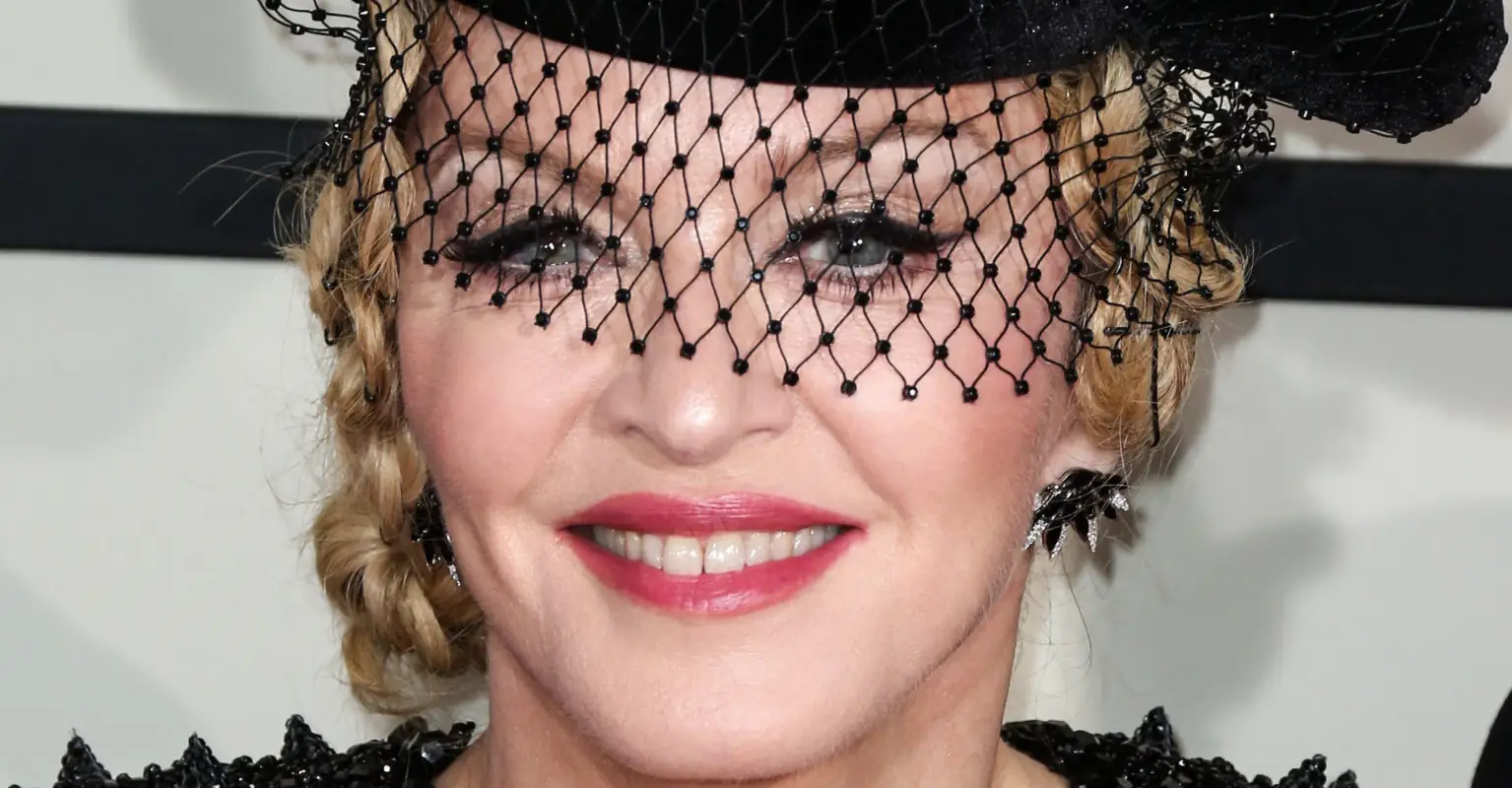 Madonna poses in crop top and hot pants to show off 'beautiful scar' on her leg