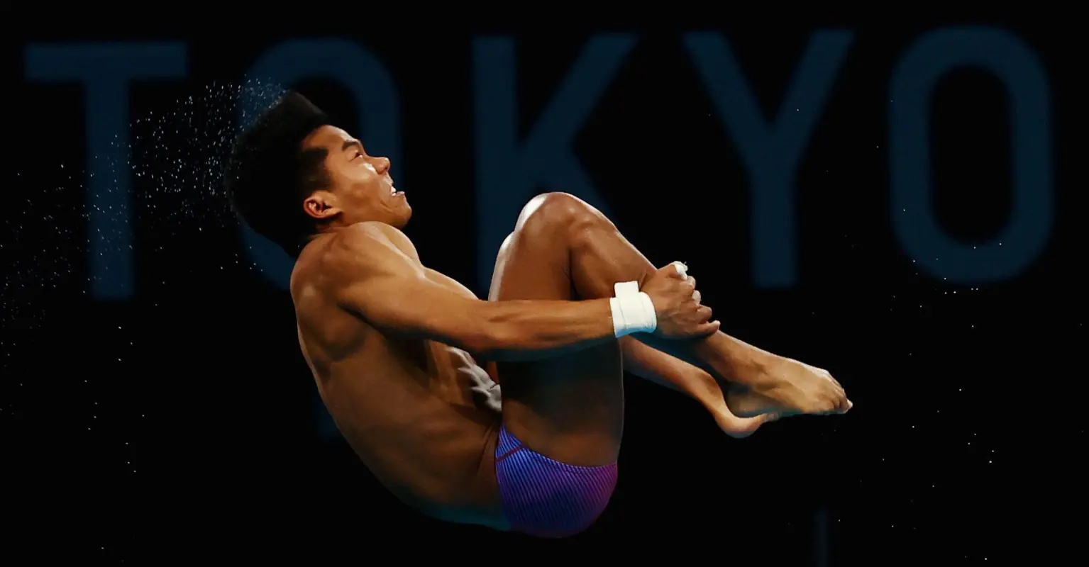 Single gay dad hailed an 'inspiration' as he adopted ill child and raised an Olympic champion