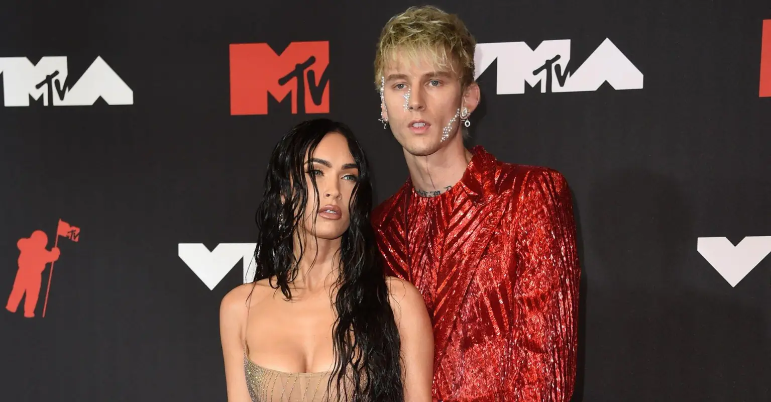 Machine Gun Kelly and Megan Fox walk red carpet chained to each other's nails