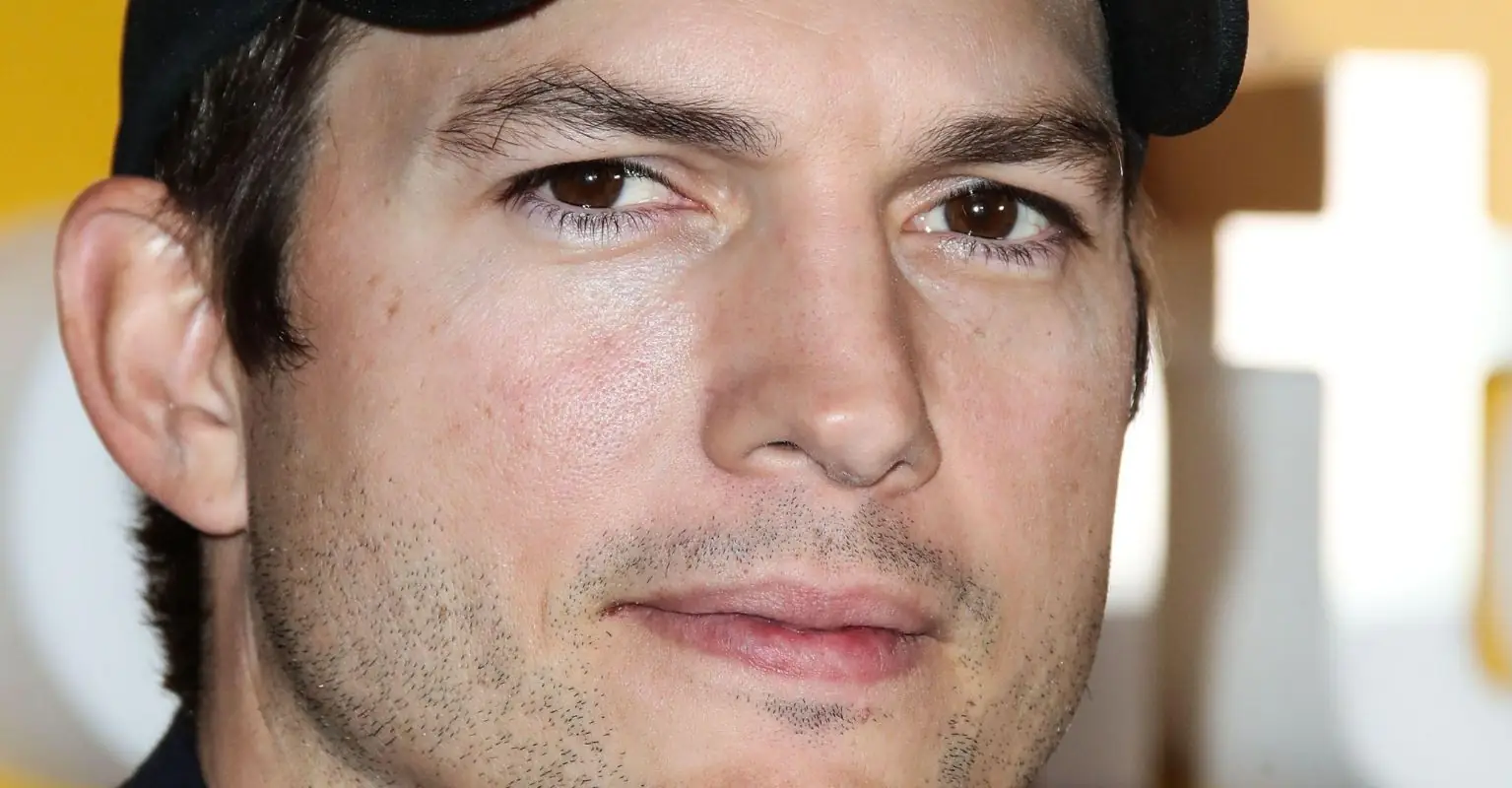 Ashton Kutcher remains calm as fans tell him to 'take a shower' at football game