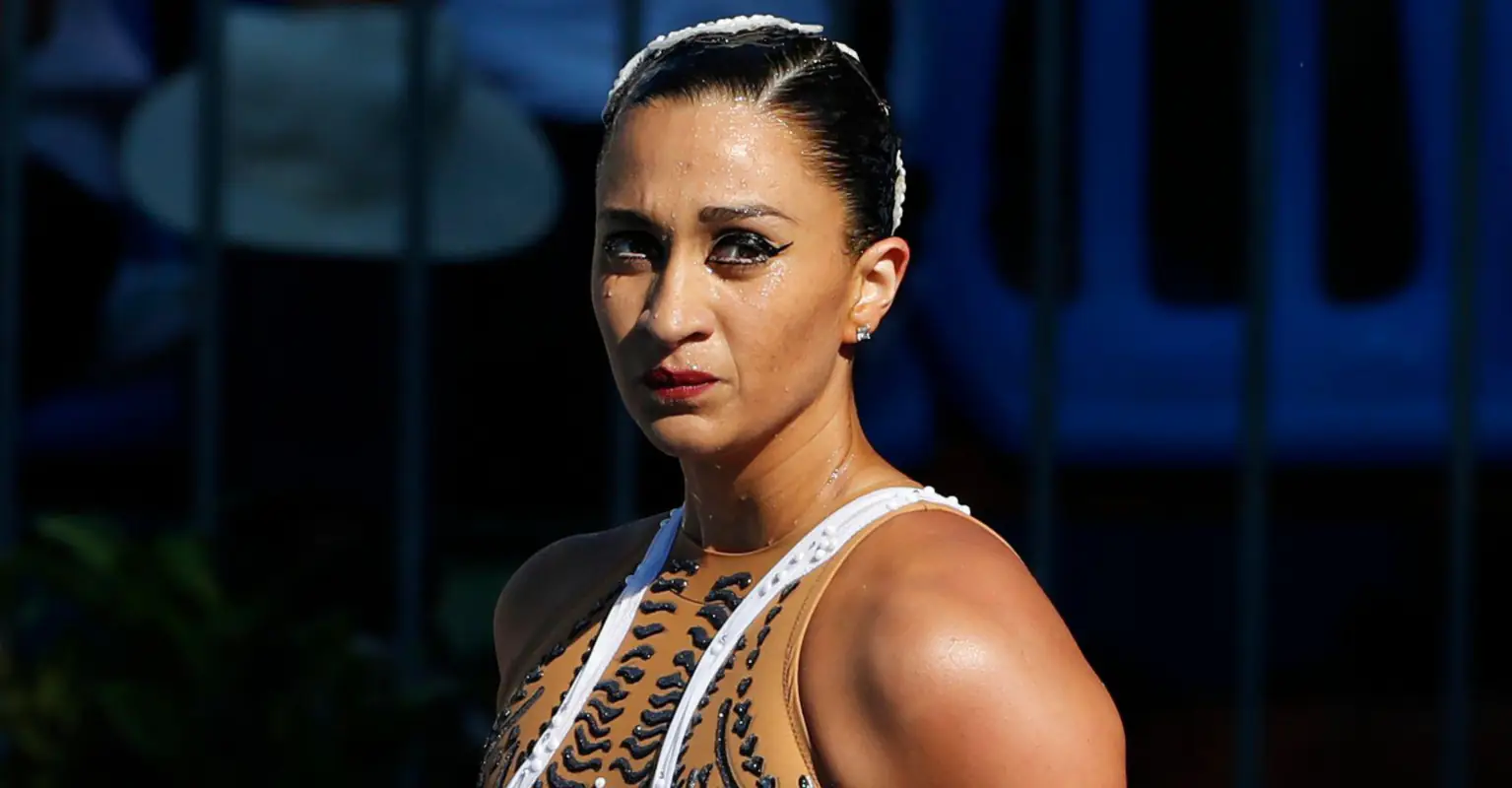 Hero coach rescues swimmer after she faints in pool during championships