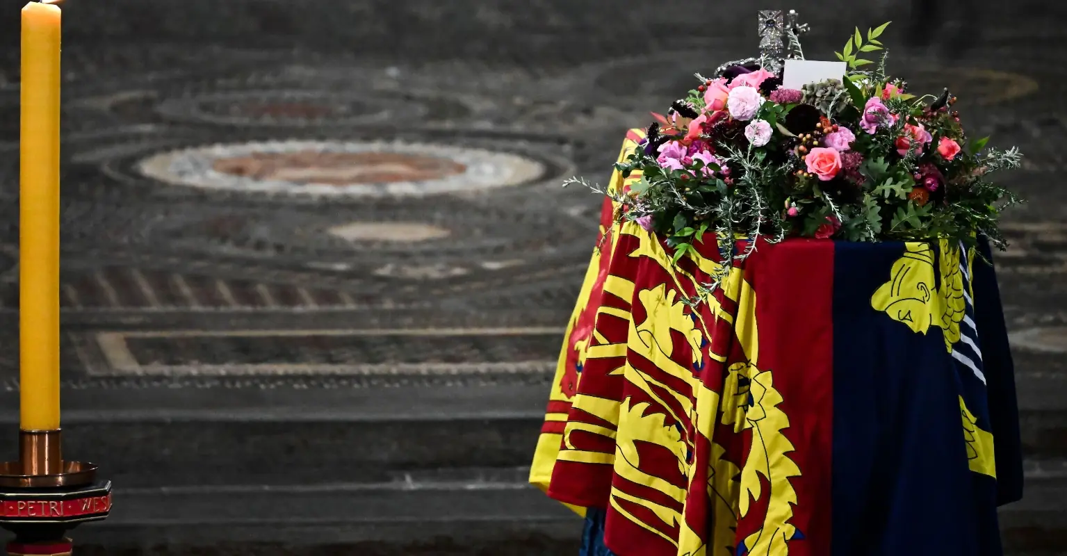 The Queen's coffin is lowered into the royal vault by Garter King of Arms