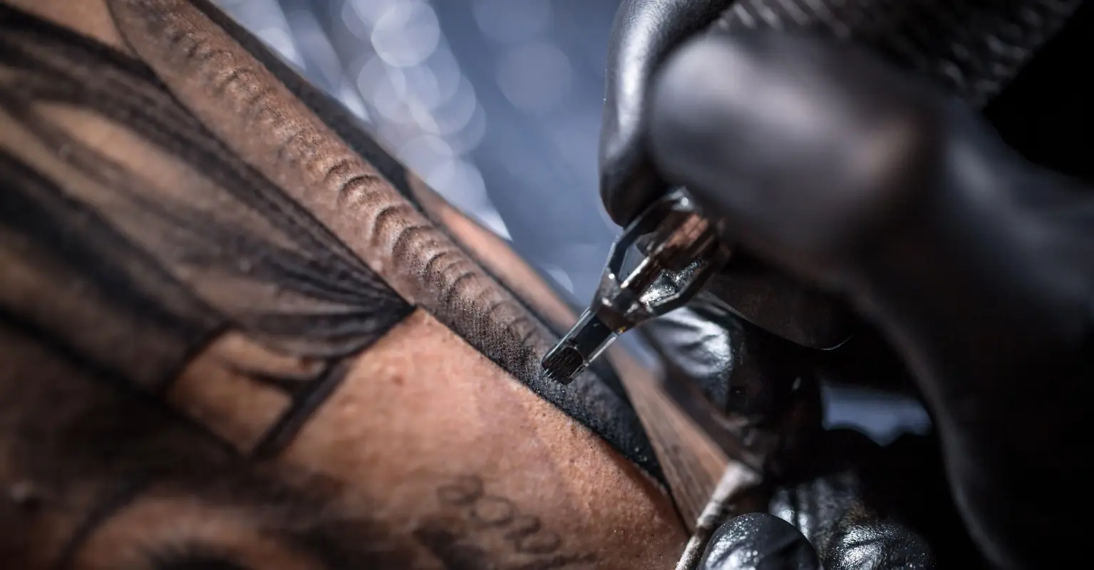 Tattooed man says he was hidden from bosses because of his inkings