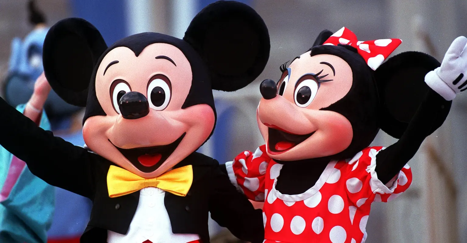 Mickey and Minnie use sign language to communicate with young deaf child
