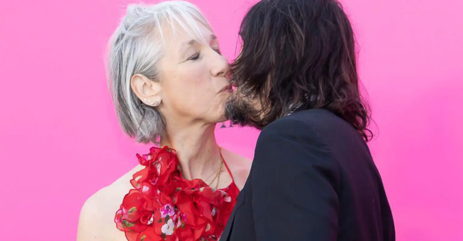 Keanu Reeves beams with happiness as he shares a red carpet kiss with girlfriend Alexandra Grant