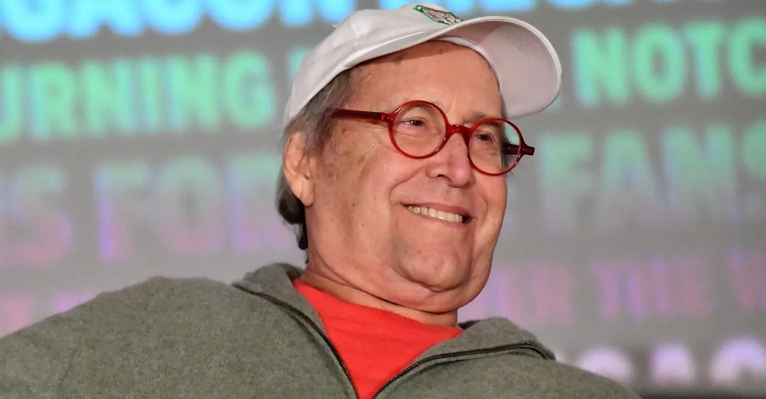 Scary moment Chevy Chase, 80, falls off stage after arriving in a wheelchair