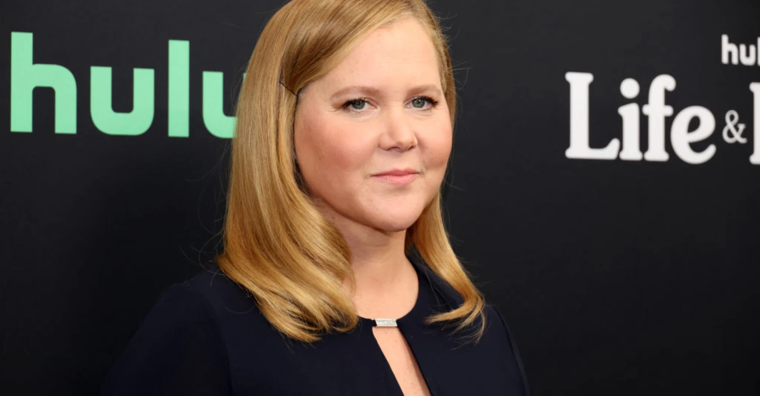 Amy Schumer celebrates her '40 extra lbs' by stripping down to her underwear