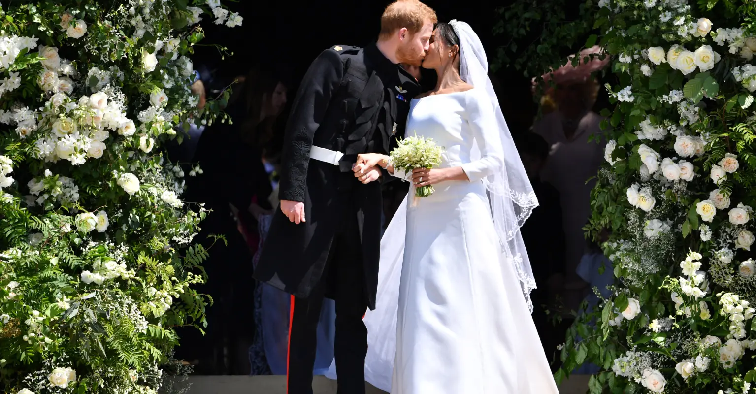 Queen Elizabeth II's savage two-word criticism of Meghan Markle's wedding dress revealed by royal biographer