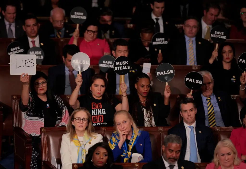 Democratic members of Congress hold up signs in protest. Credit:	Chip Somodevilla / Getty