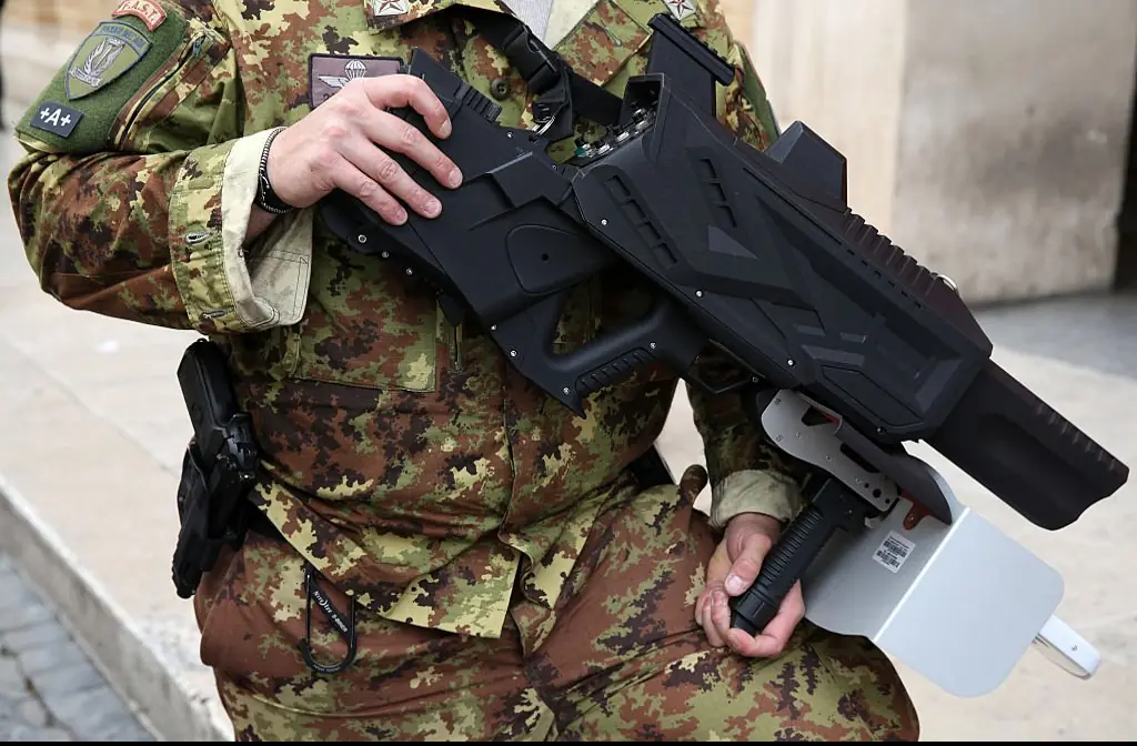 Another military officer holding an anti-drone gun .mCredit: Adam Berry / Getty