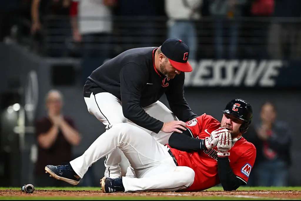 Manager Stephen Vogt attends to David Fry after the incident. Credit: Nick Cammett / Getty