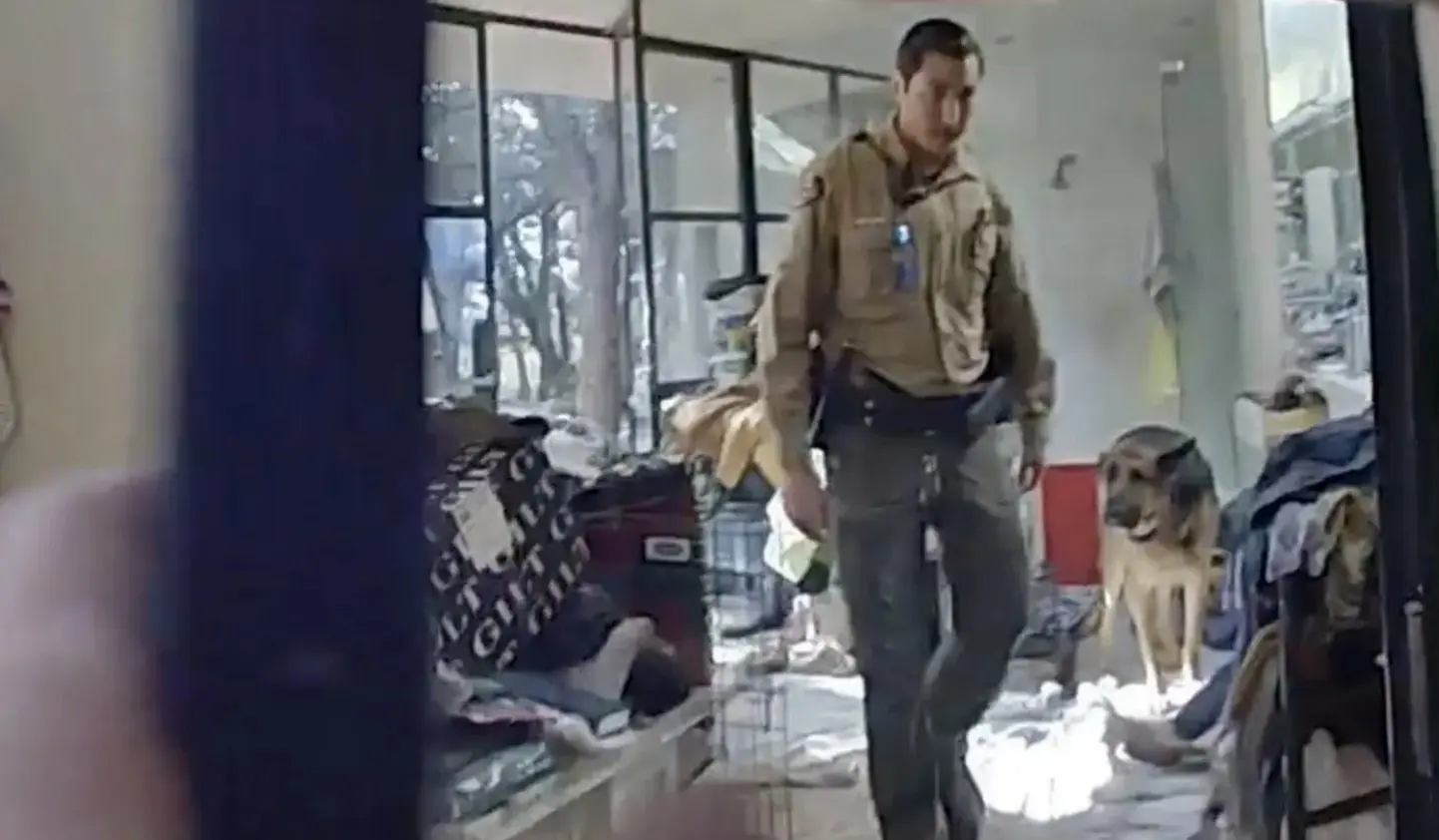 Bodycam footage shows a dog found guarding the body. Credit: Santa Fe Sheriff's Office